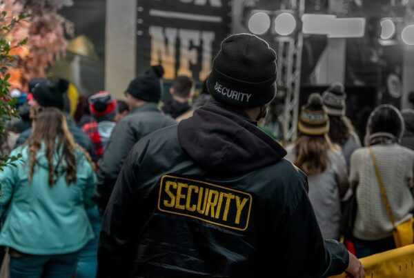 Man with security jacket in a crowd