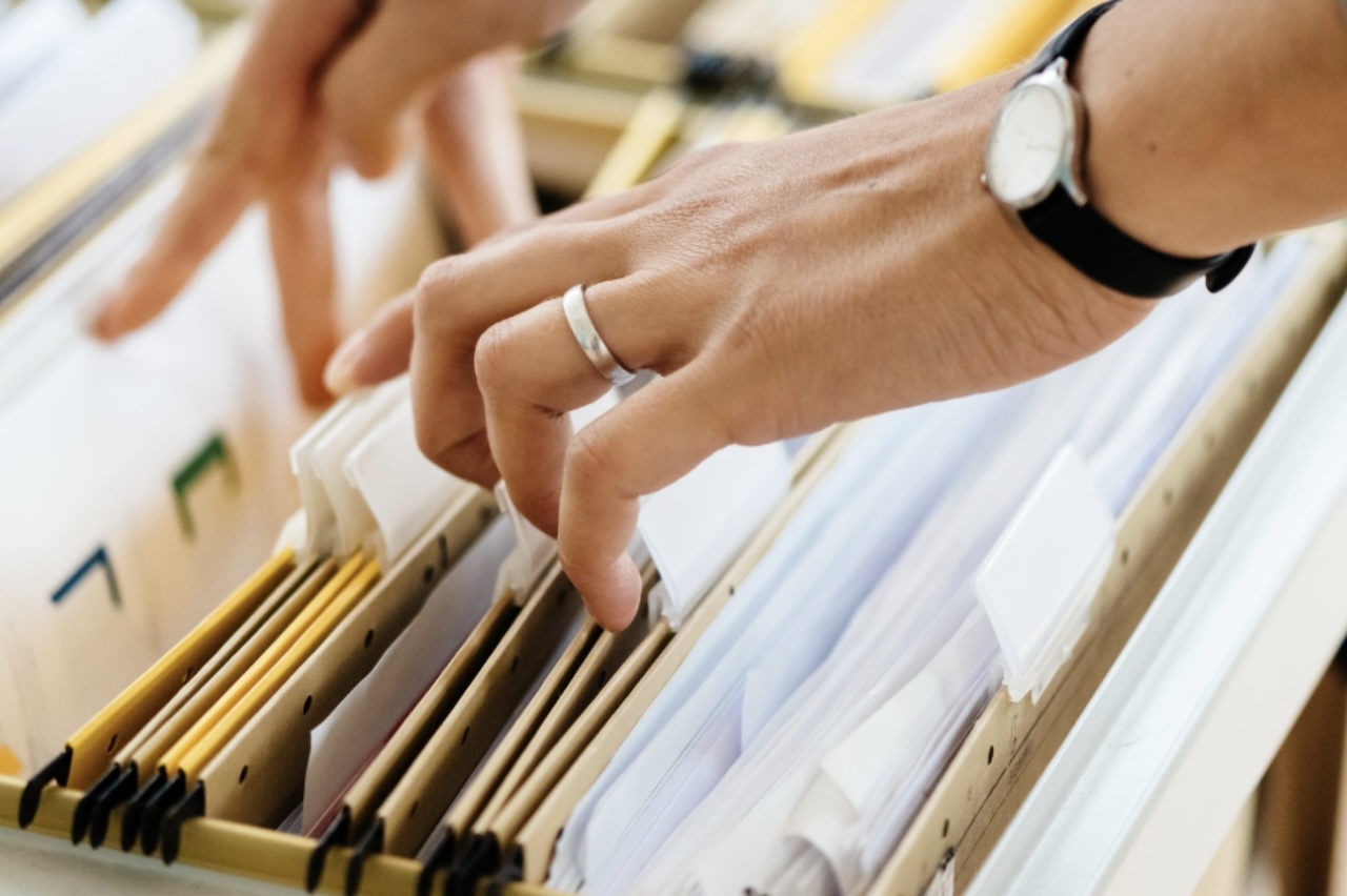 woman looking through files in filing cabinet